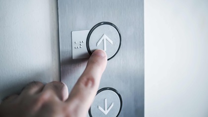 Elevator button finger pressing going up