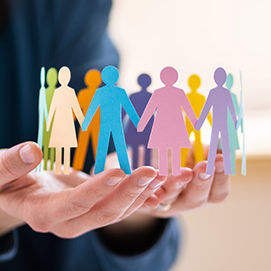 Person holding paper cut out people