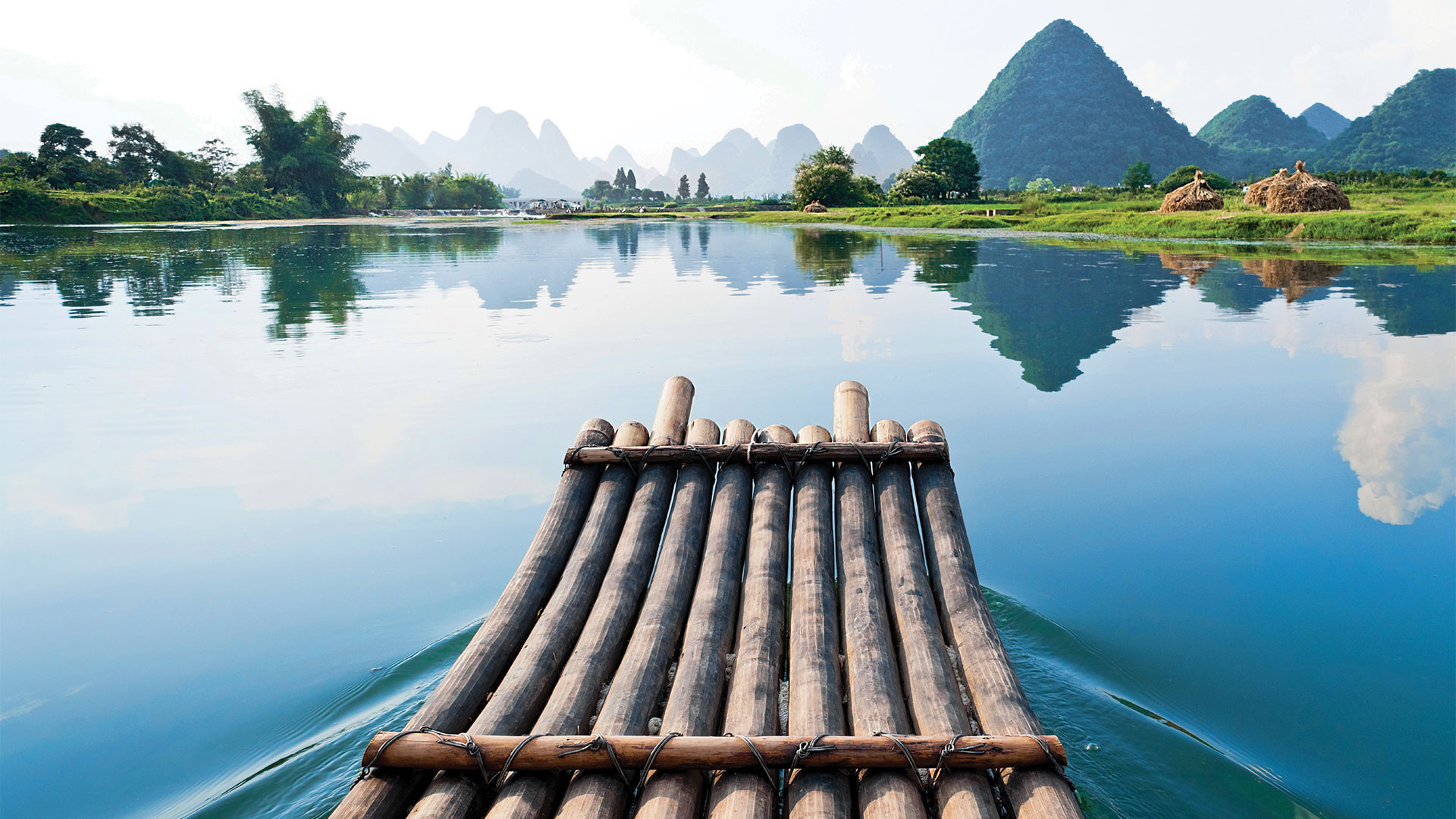 Wooden raft floating on still lake
