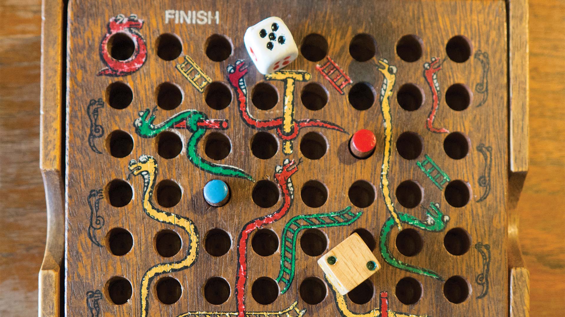 Old style board game of snakes and ladders