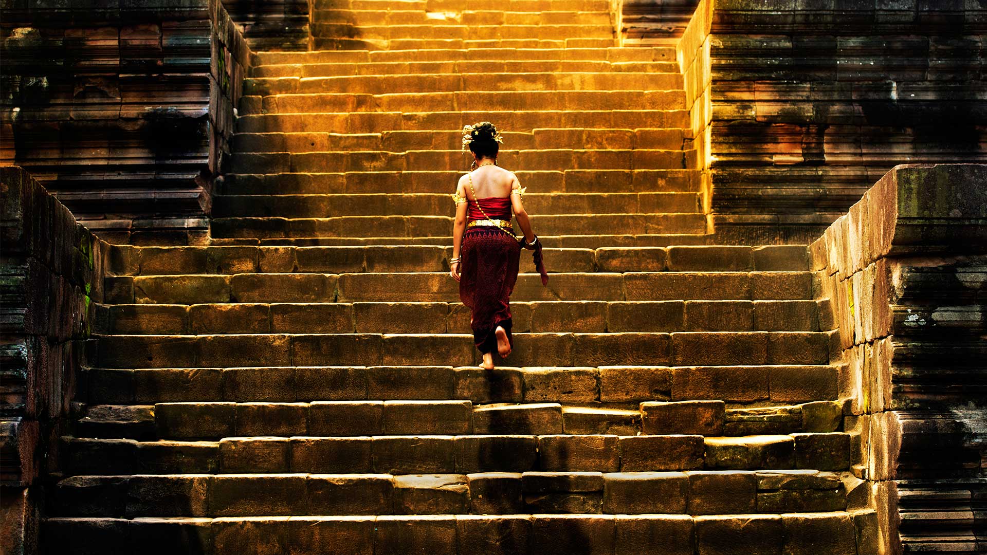 Woman climbing up stone stairs