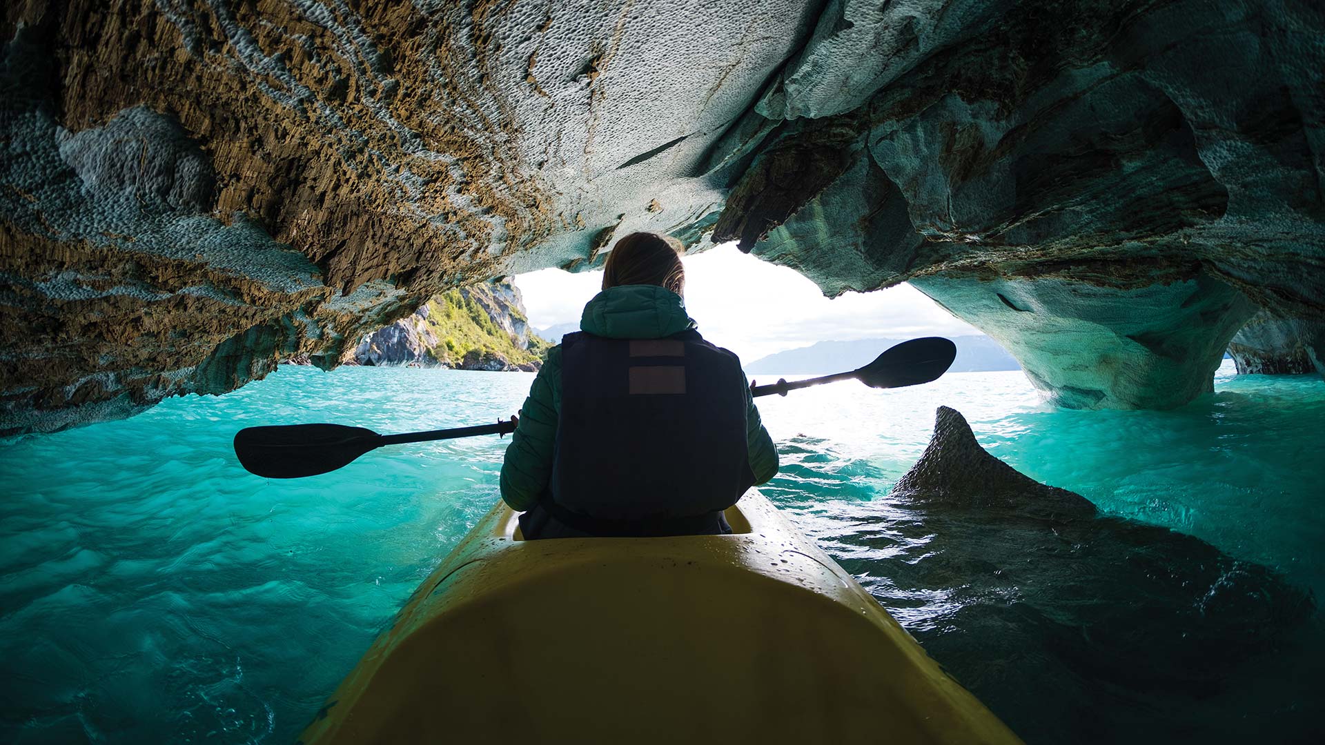 Person in a kayak exploring water cave