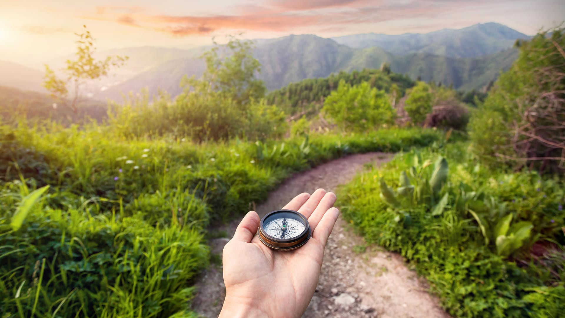 Person being guided by a compass in the beautiful mountains