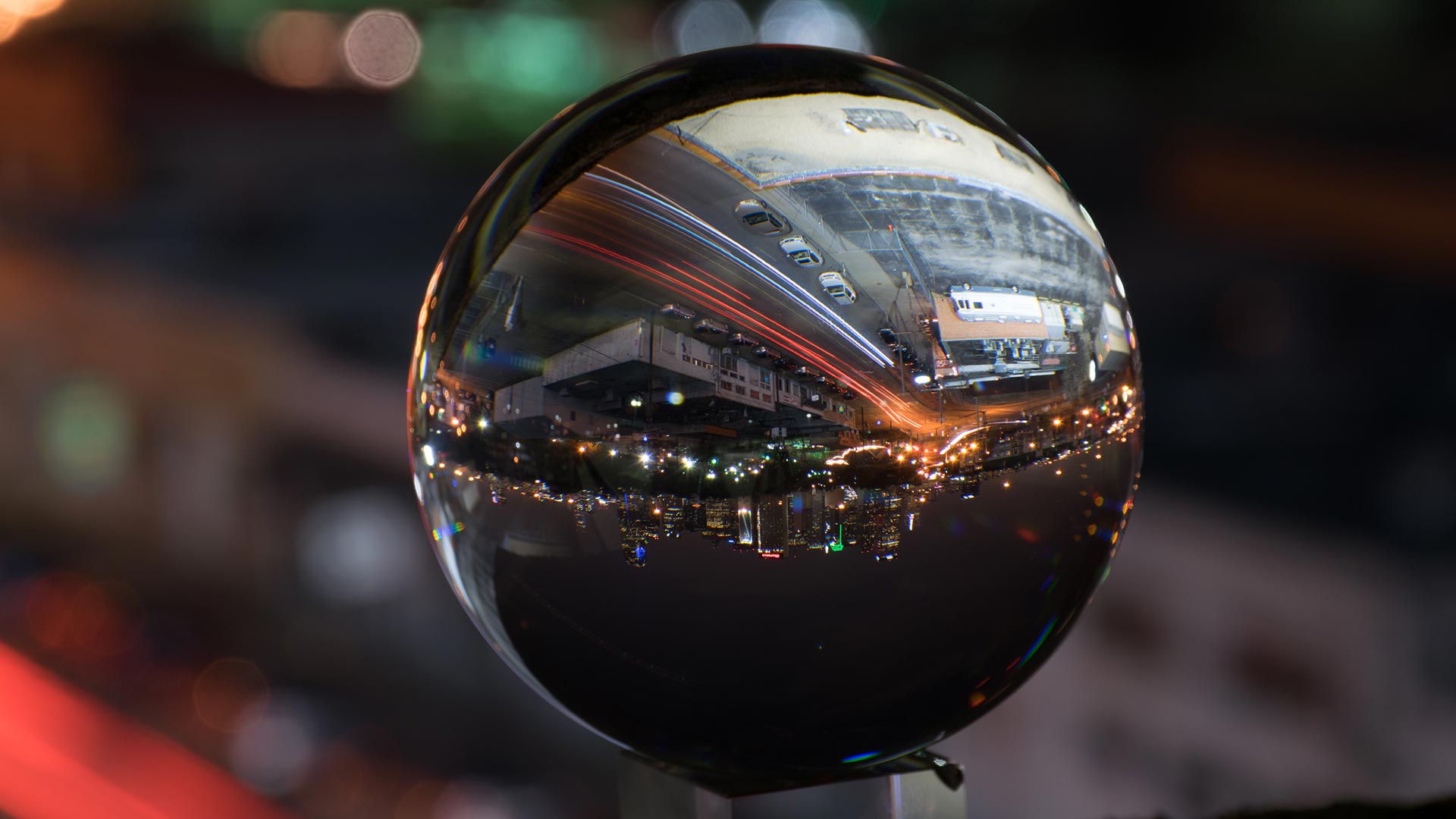 Crystal ball reflecting cityscape upside down at night