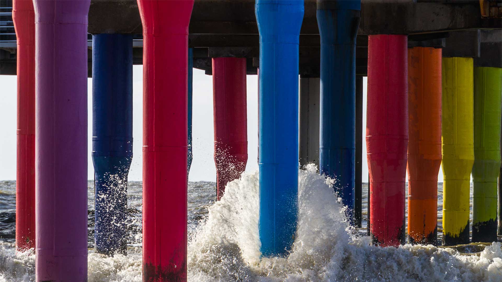 Multi coloured posts of a jetty