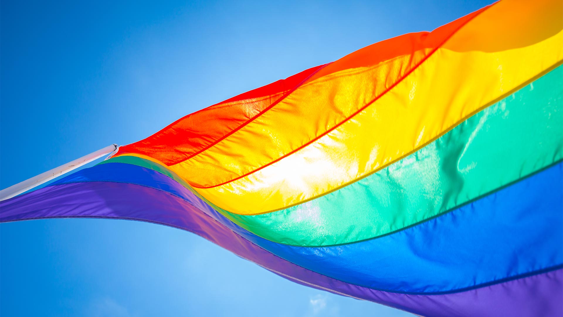 multi-coloured flag representing non-binary and transgender customers