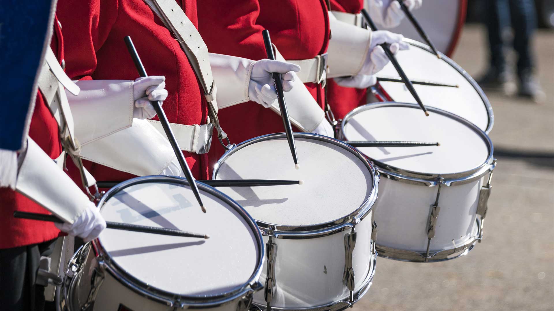 Red uniformed drummers in a row