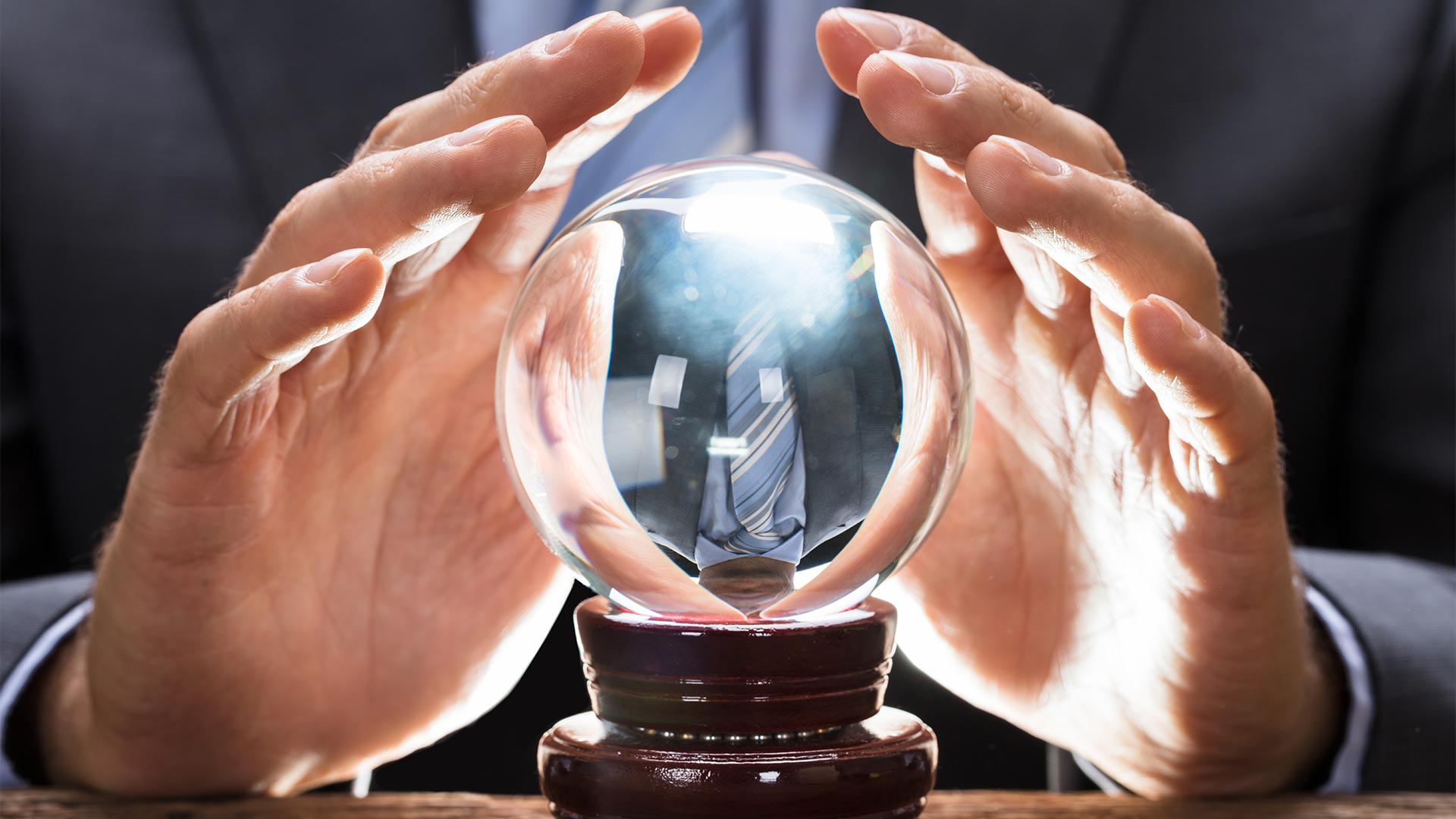 Businessman covering a crystal ball