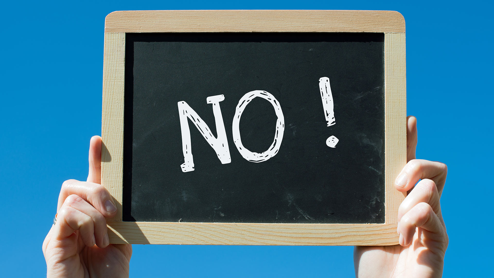 Woman holiday up blackboard that says no!