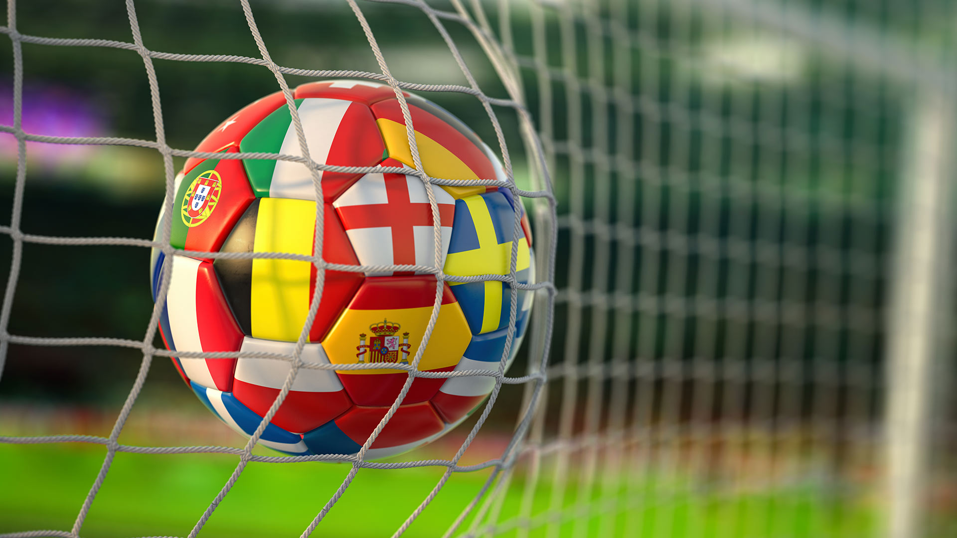 Football in the back of the net covered in different countries flags