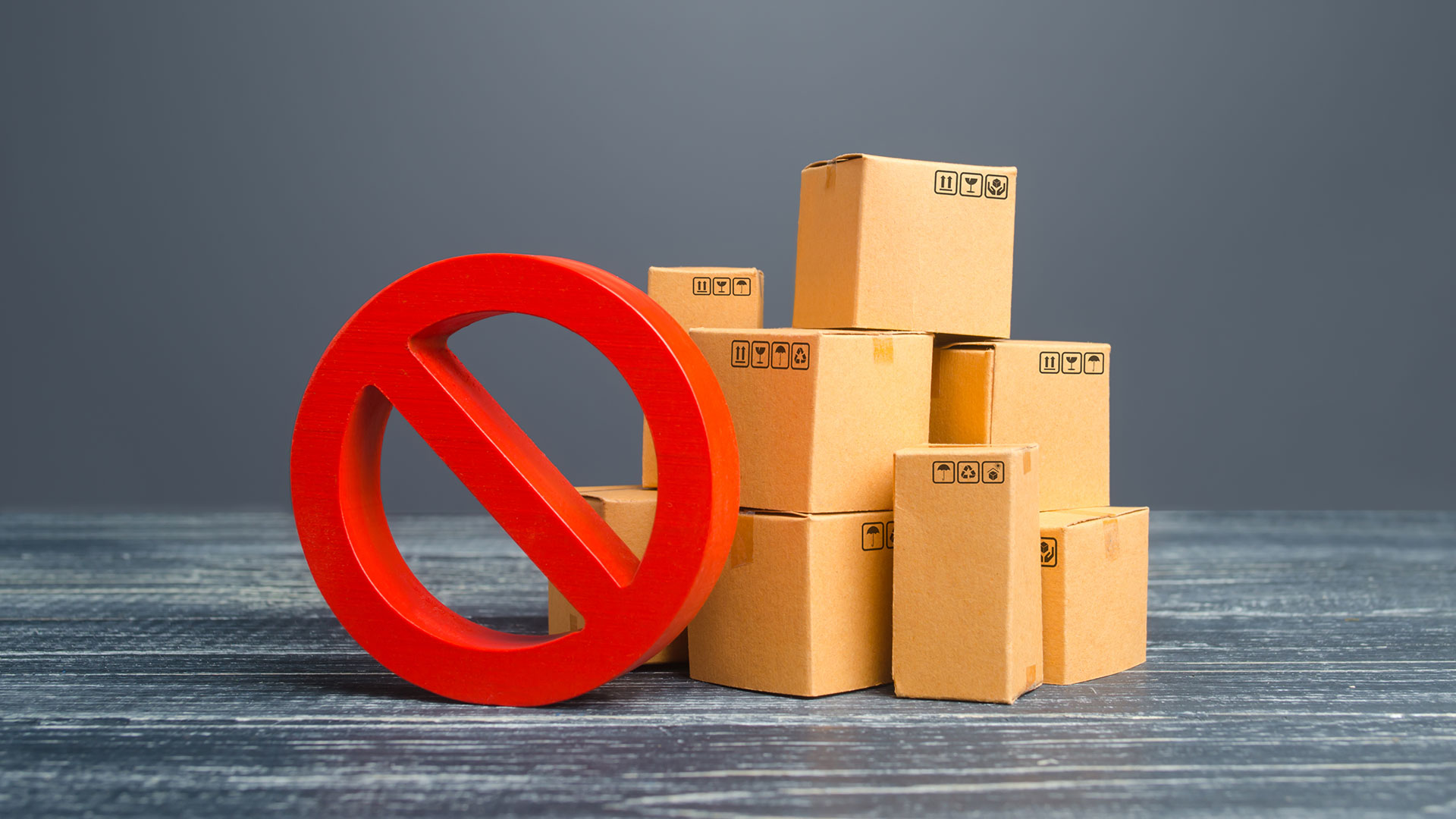 Small boxes stacked with a big red ban icon in front
