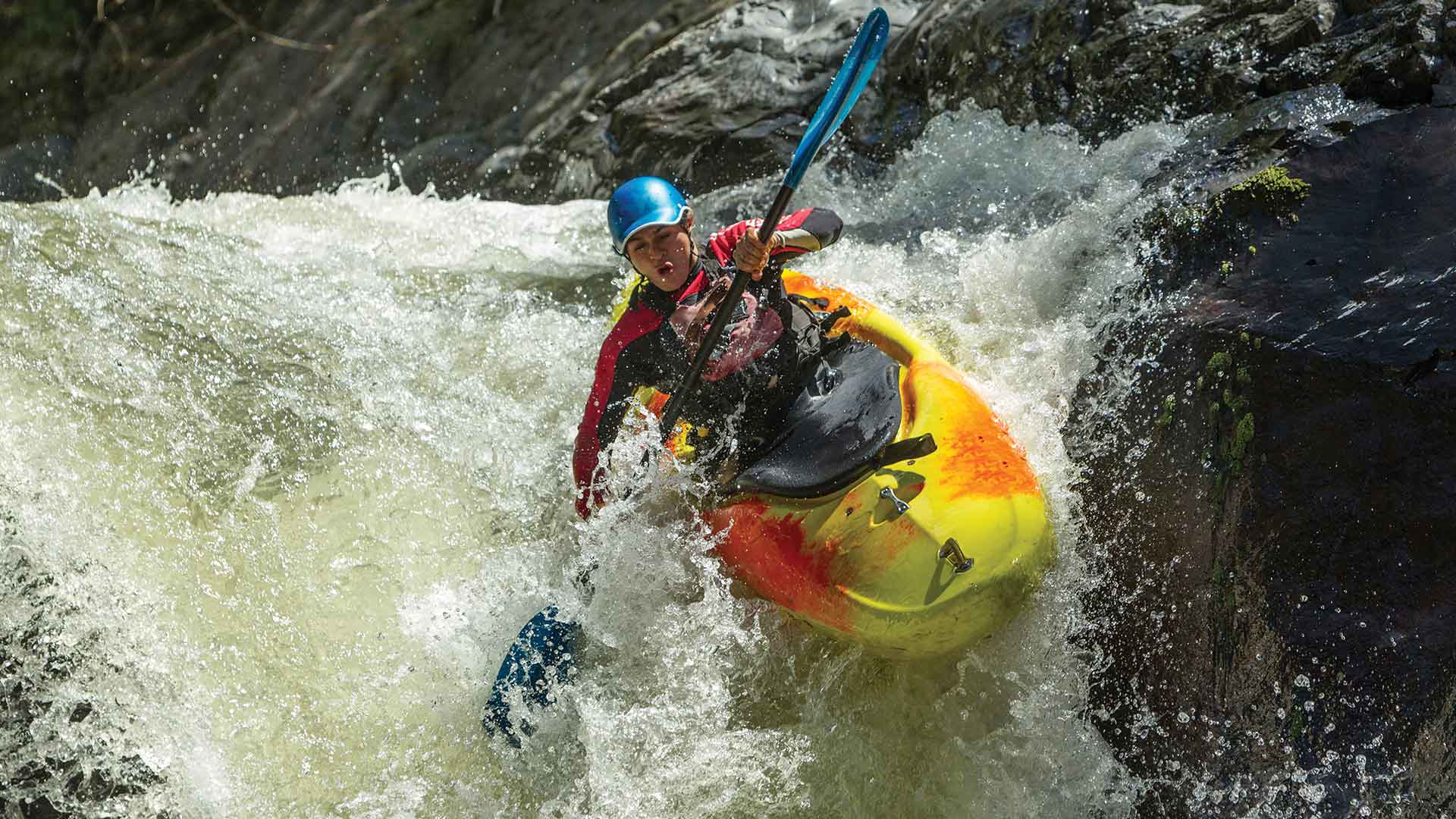 Kayaker going down a waterfall 