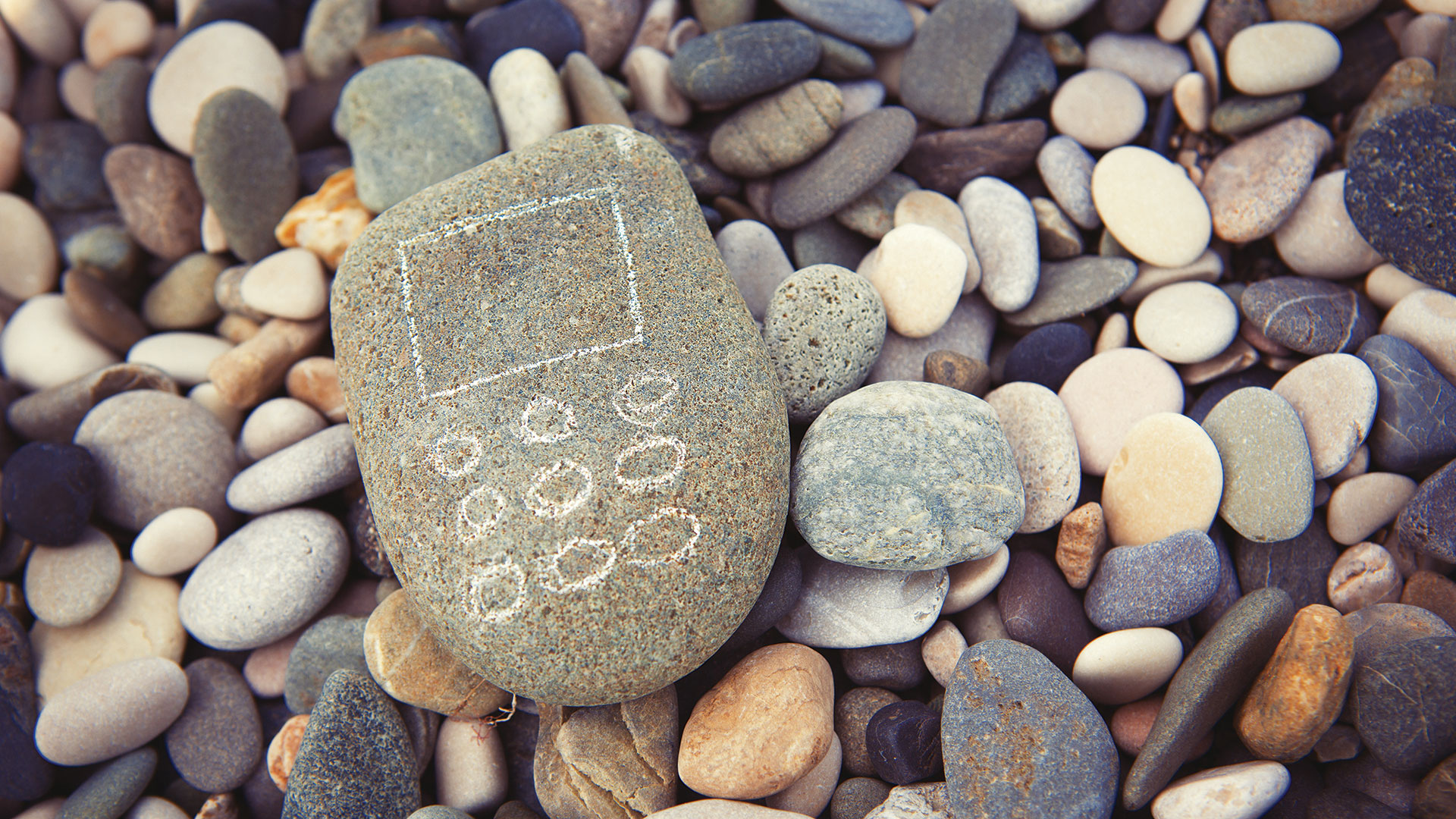 Mobile phone from stones on beach