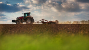 Farmers tractor preparing the land for seed