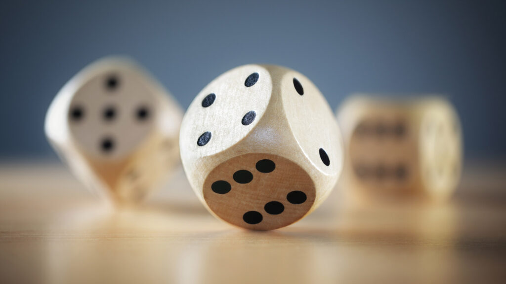 Three dice being rolled