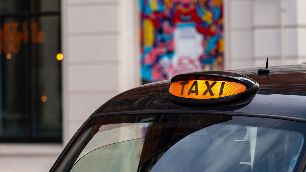 Black cab taxi sign in London