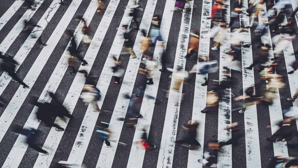 Lots of people crossing the road at zebra crossing