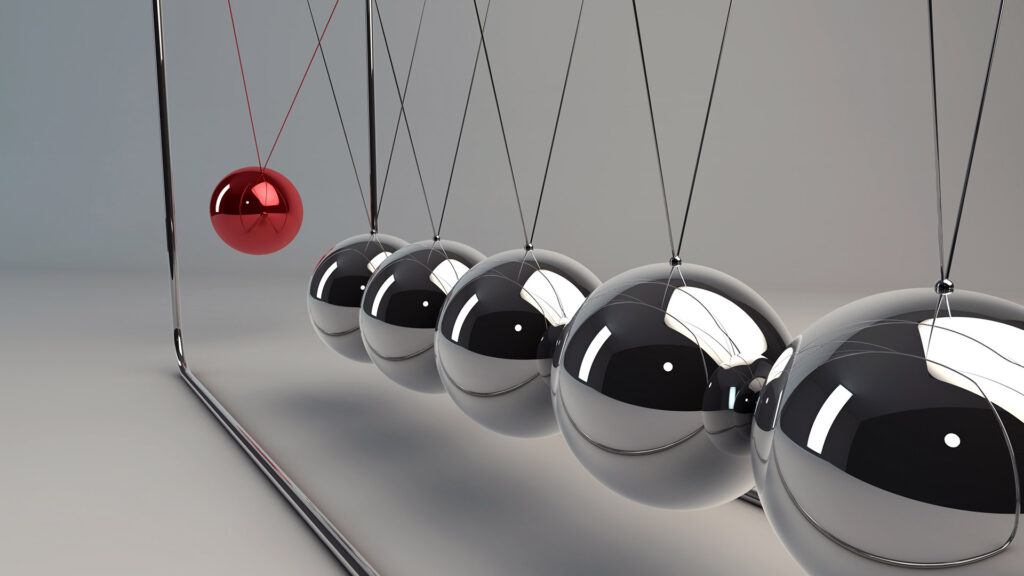 Close up of Newton's cradle in swing