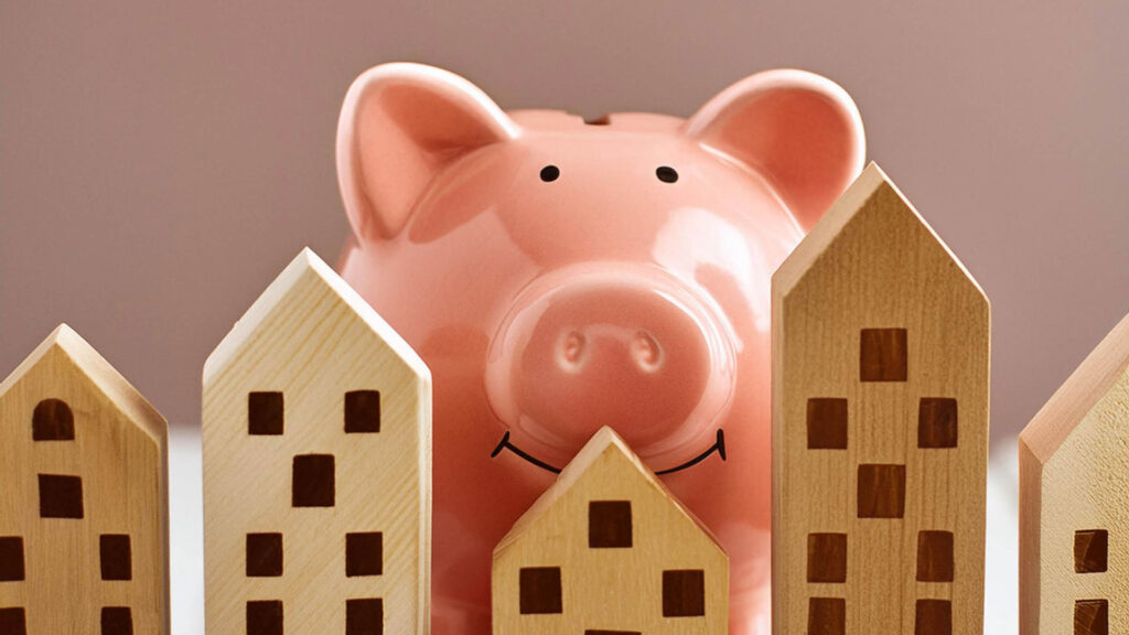 Piggy bank behind wooden houses