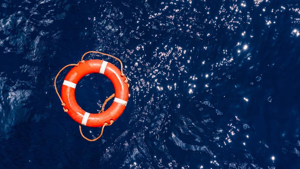 Orange buoy floating at sea