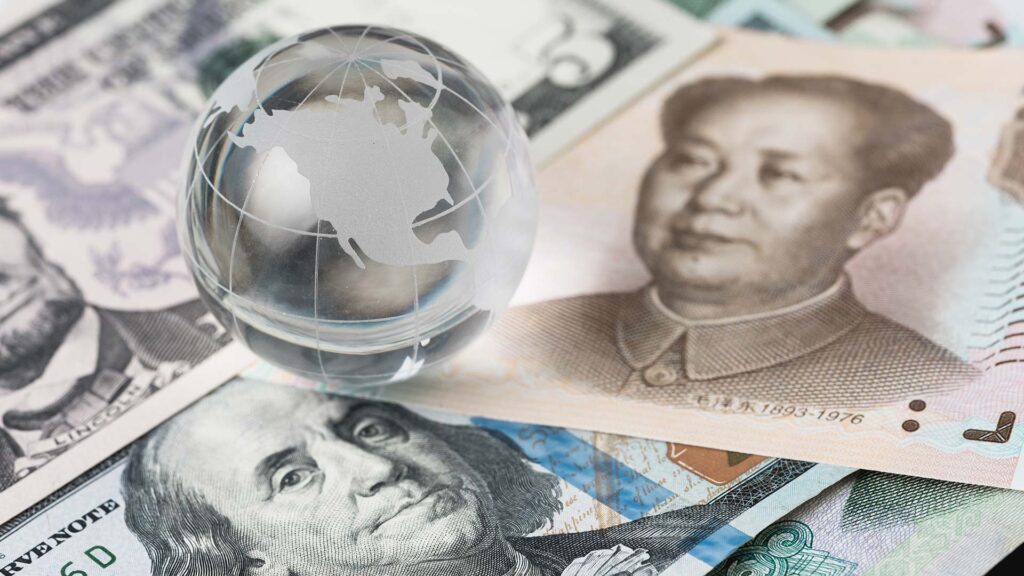 US and Asia bank notes mixed together with glass globe