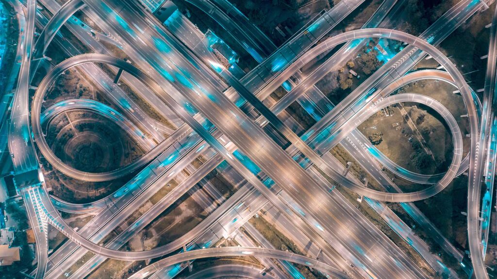 Winding busy roads with car light trails