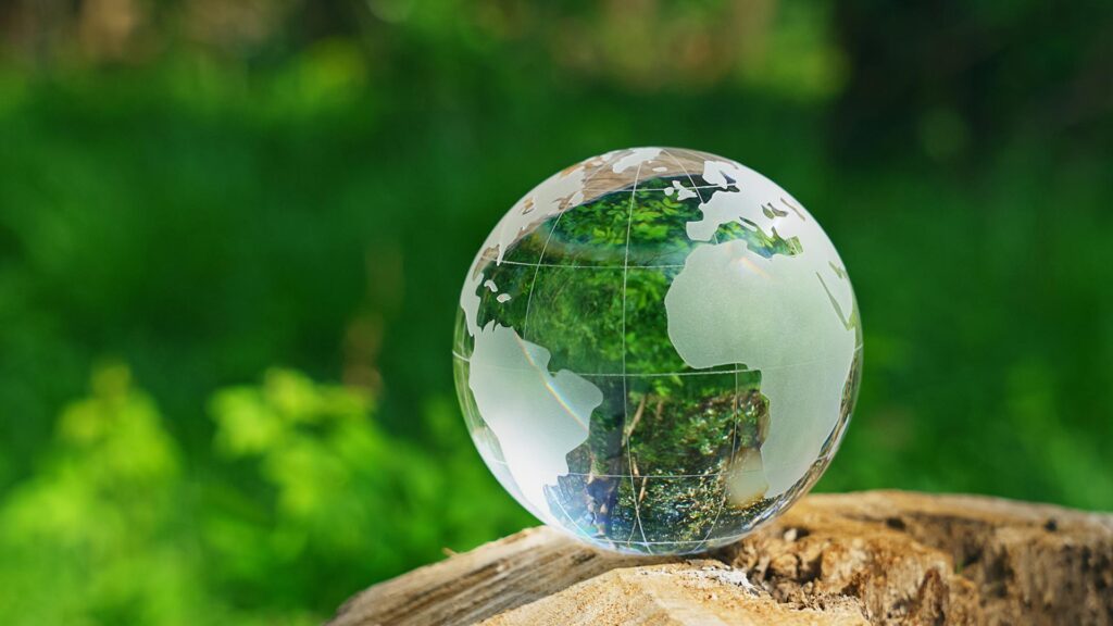 Glass globe showing Europe, resting on a rock outside