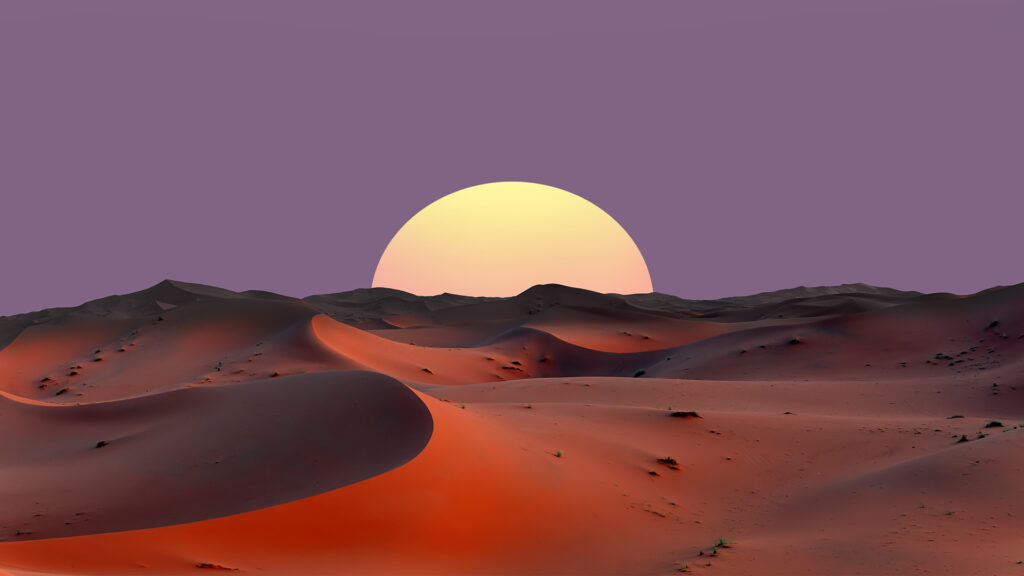 Sun rising over sand dunes in the Sahara Desert