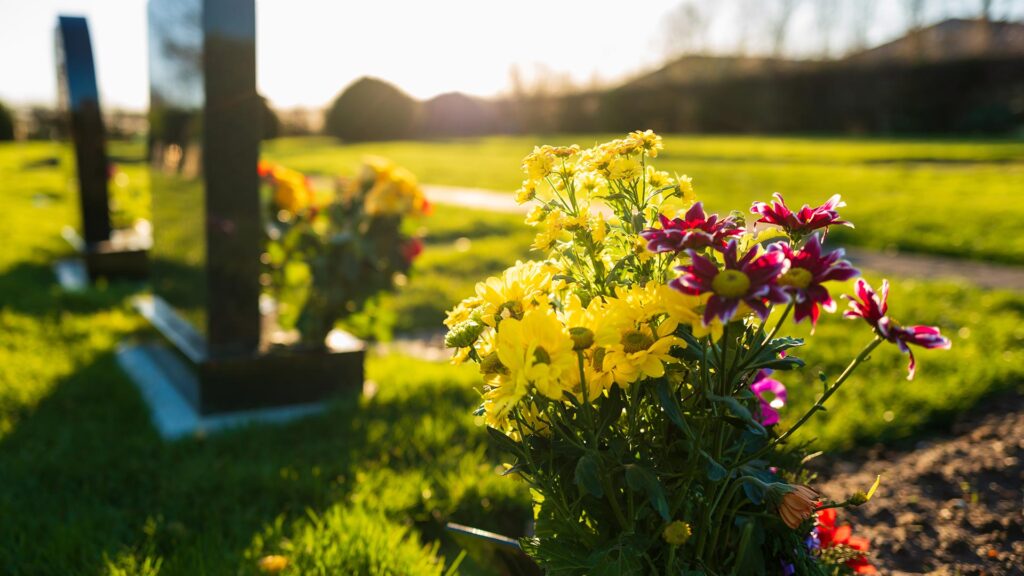 Flowers at a graveyard with the sun setting