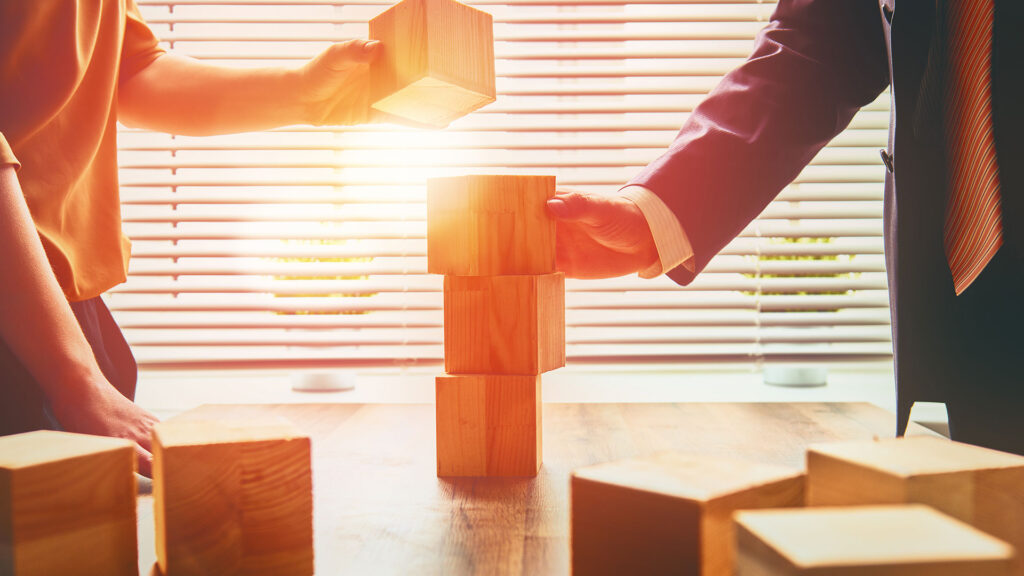 People using building blocks to build a plan