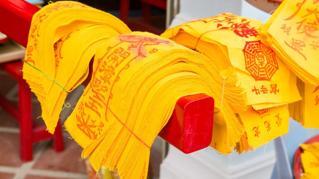 Yellow Chinese talismans being prepared