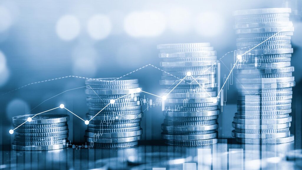 Stacks of coins increasing in the amount with charts and graphs overlaying