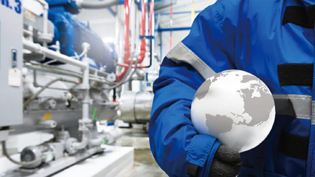 Person holding a globe in a factory
