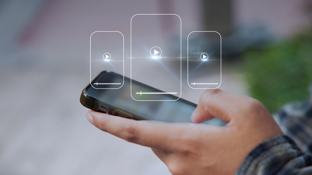 Person using mobile phone to watch videos