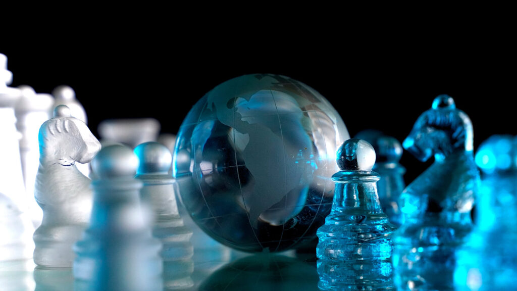 Crystal globe on chess board.