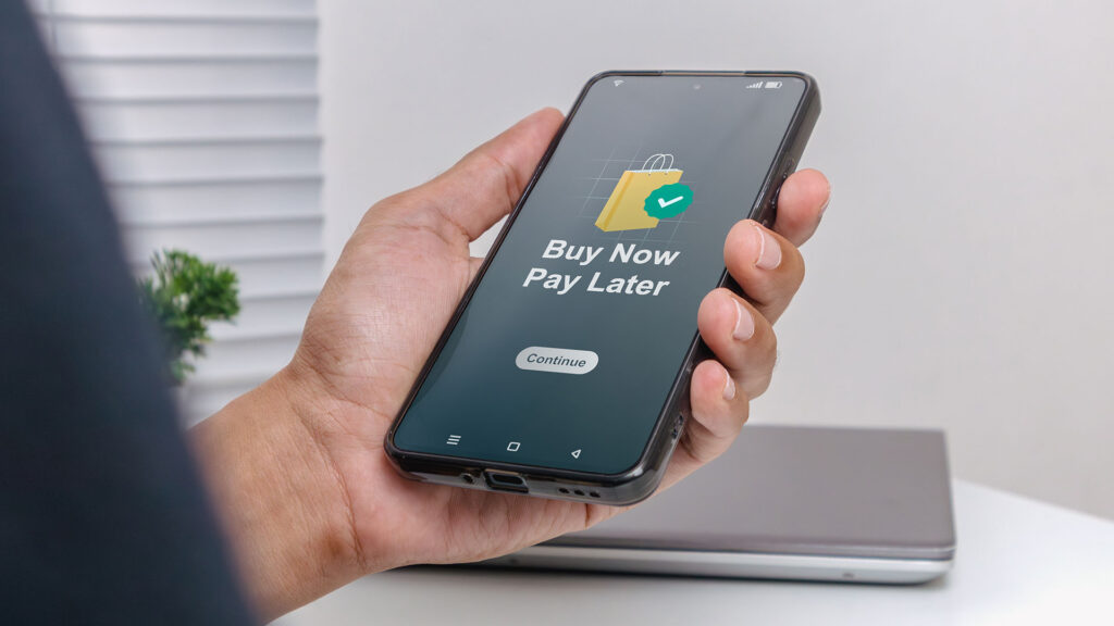 Person using mobile phone to buy now and pay later