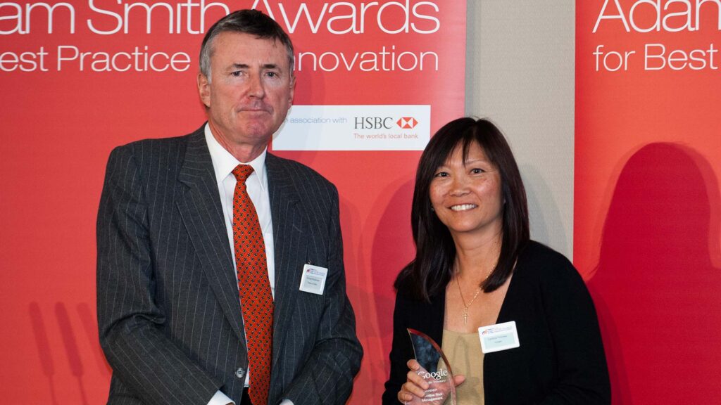 Photo of Richard Parkinson and Cynthia Torsney from Google accepting on behalf of Axel Martinez.