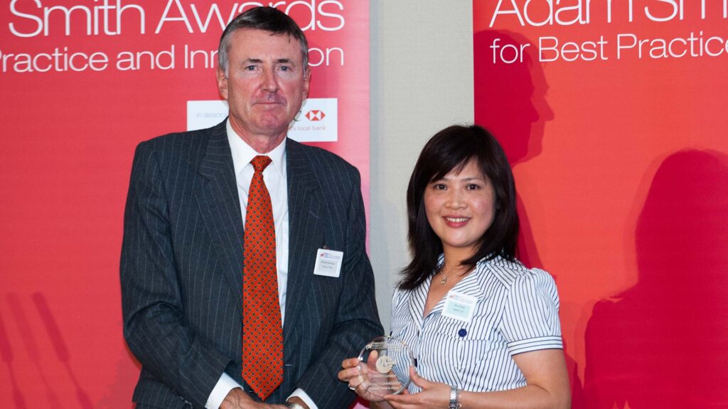 Photo of Richard Parkinson and Alice Zhang from CNOOC Ltd. accepting on behalf of Xiaofeng Huang.