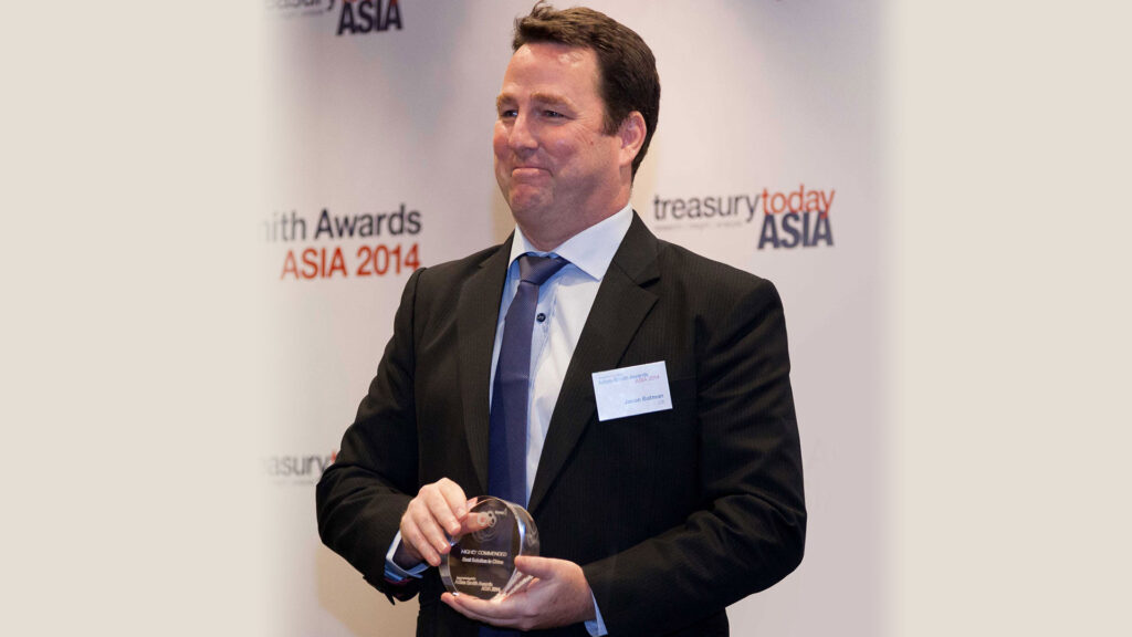 Photo of Jason Batman of Citi collecting the award on behalf of Amway (China).