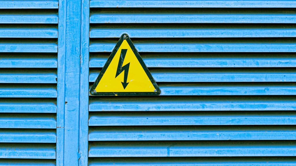 Voltage danger sign on blue gate.