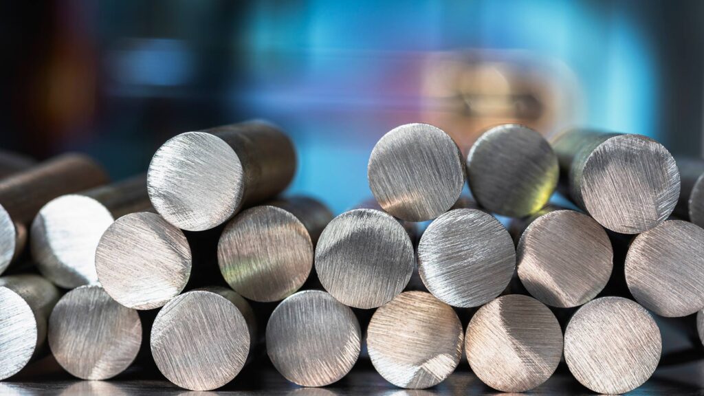 Stack of steel rods in factory.