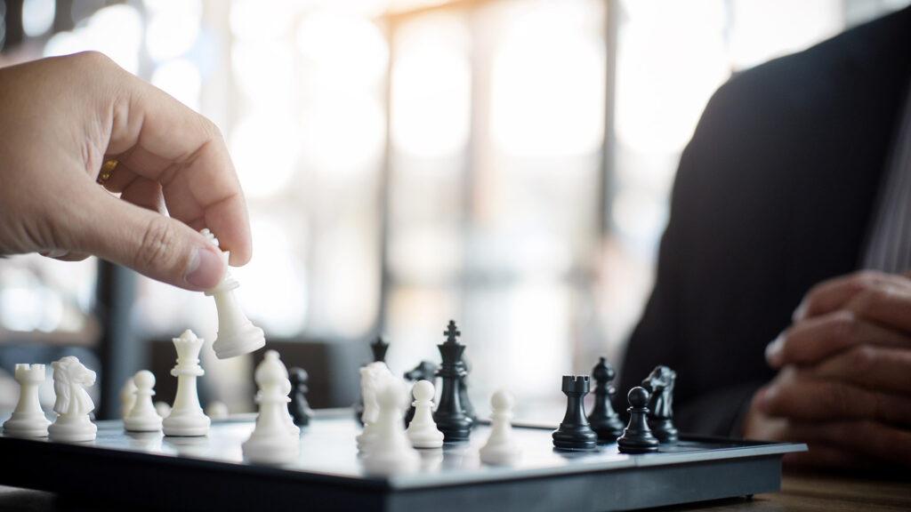 Business people playing chess.