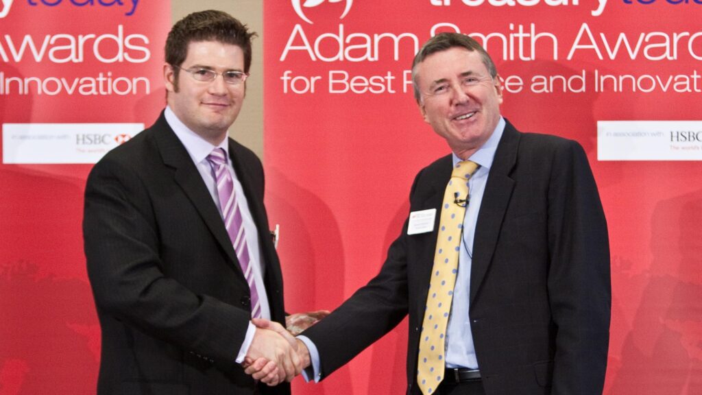 Photo of Bart Wenstrom from Microsoft accepting on behalf of Nancy Wells, Richard Parkinson.