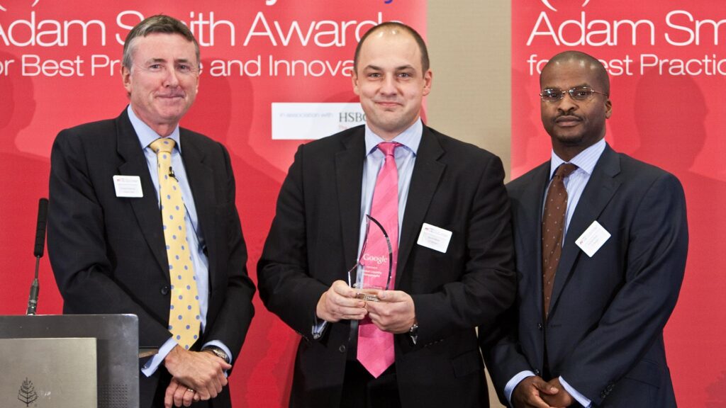 Photo of Richard Parkinson, David Aldred and Anthony Ross from J.P. Morgan accepting on behalf of Ronni Horrillo.