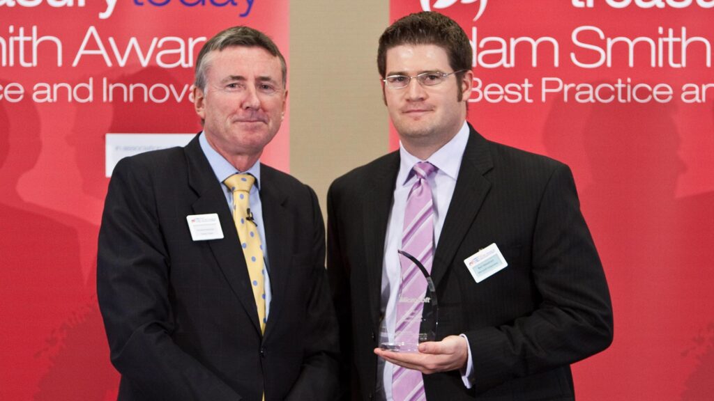 Photo of Richard Parkinson and Bart Wenstrom from Microsoft accepting on behalf of Doug Hoch.