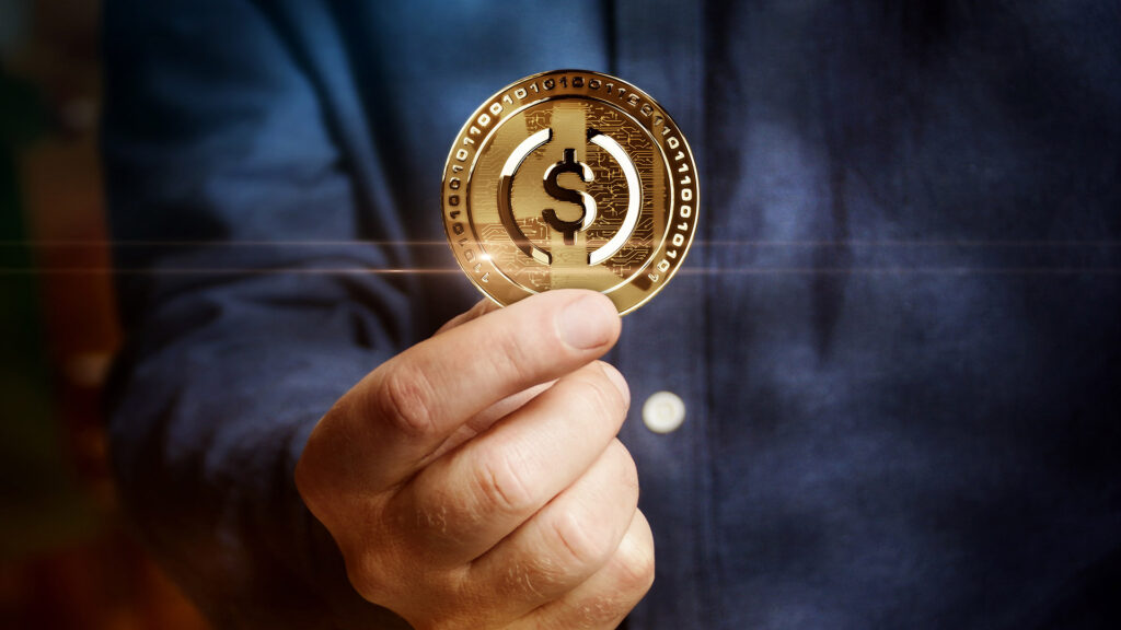 Hand holding US stablecoin.