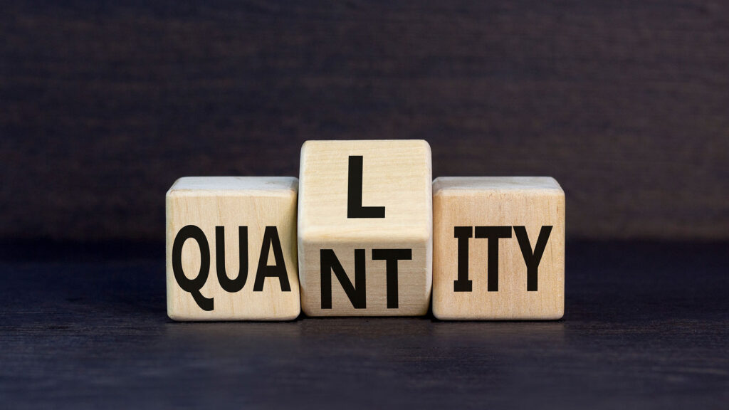 Wooden blocks spelling out quality and quantity