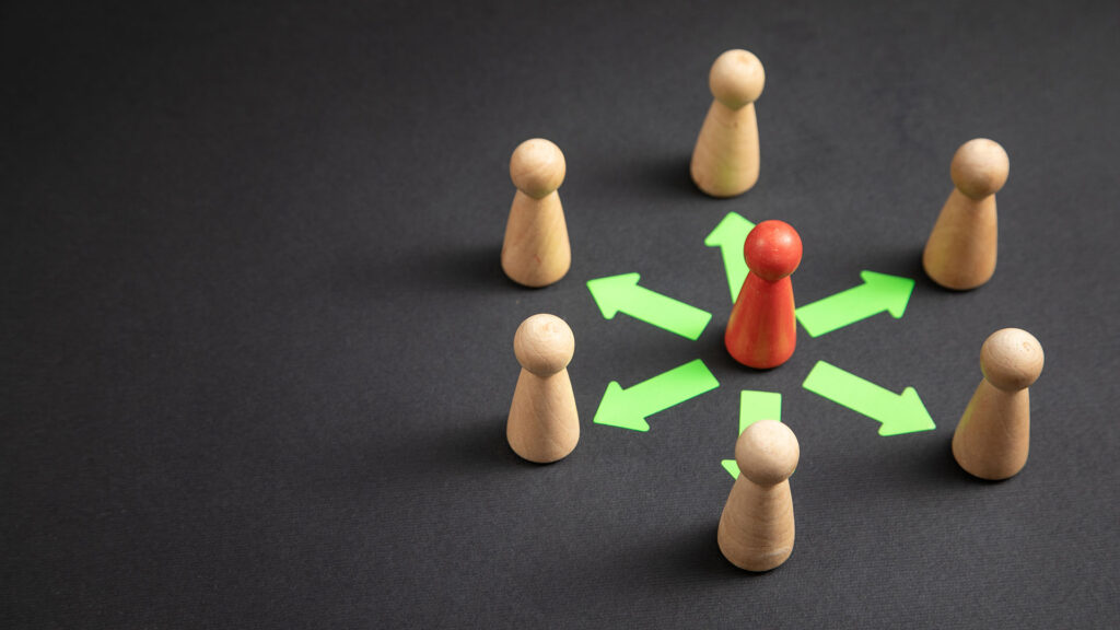 Wooden human figures showing concept of delegation