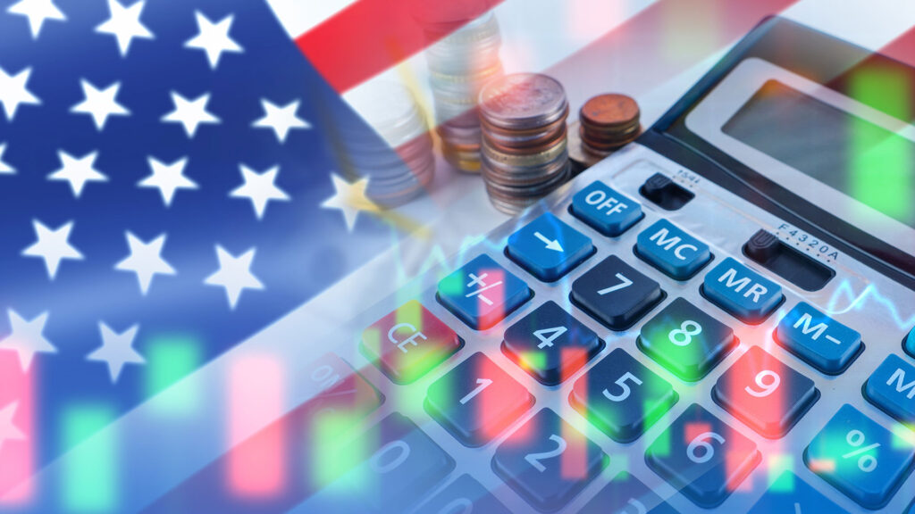 US flag with stocks and calculator.