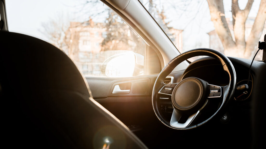 Car drivers seat with sunny background.